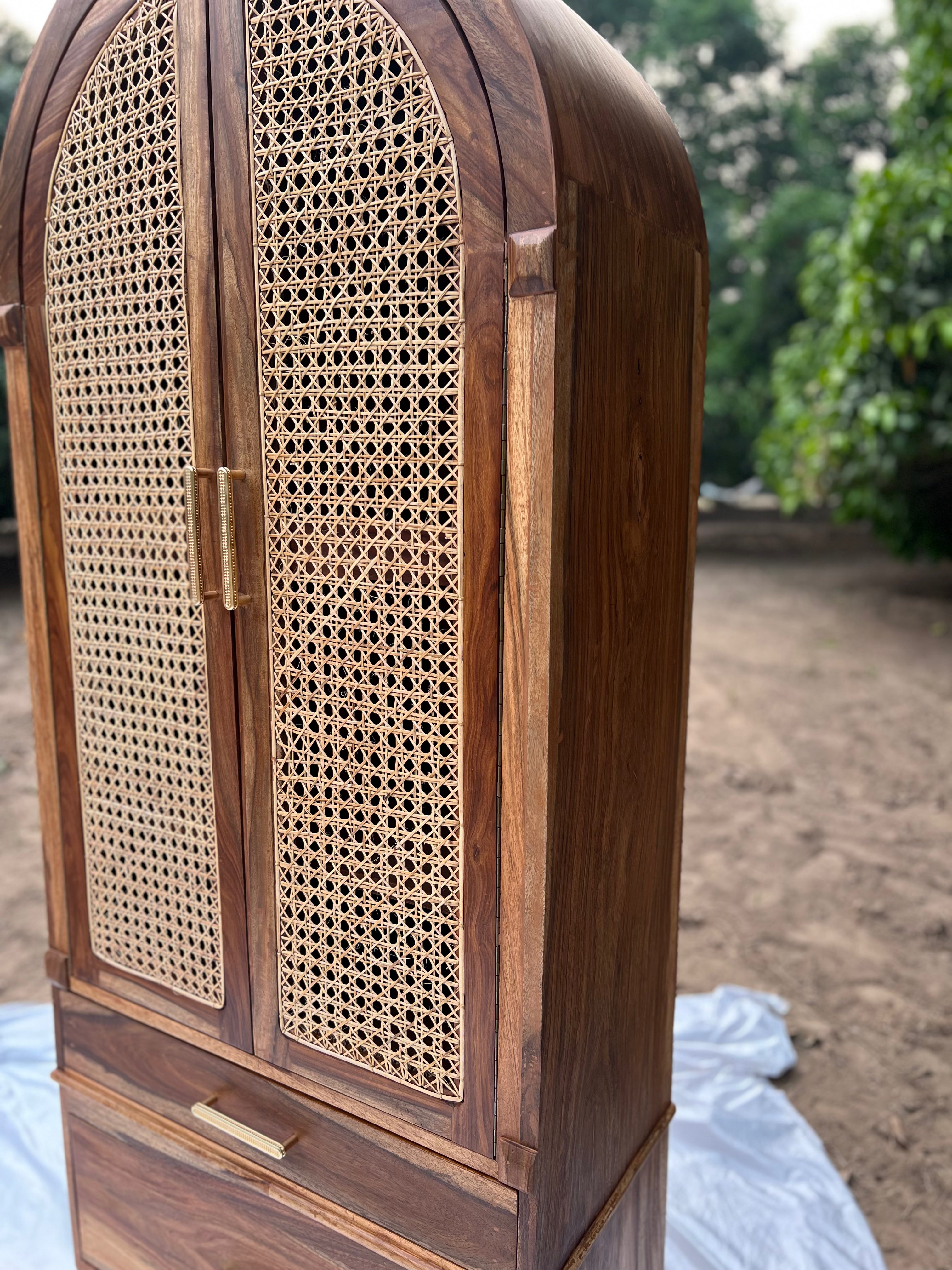 "Cane cupboard styled in bedroom setting"