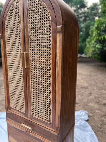 "Cane cupboard styled in bedroom setting"