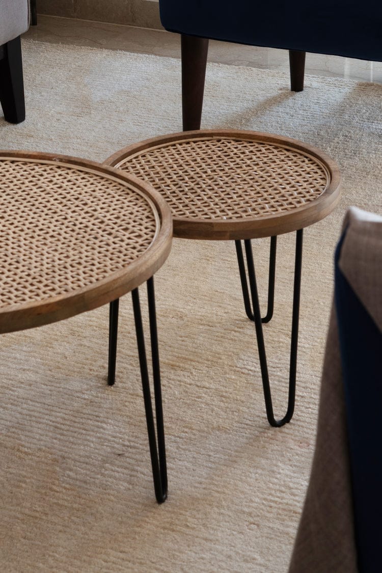 "Close-up of hand-woven rattan lacing on nesting table top"