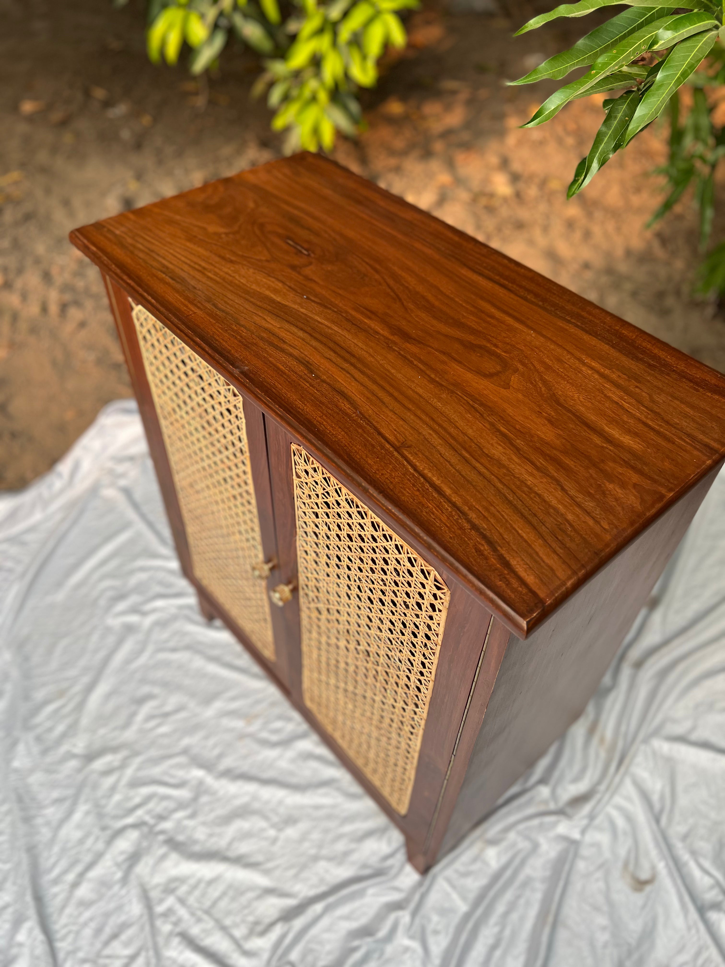 Close-up of wood grain and cane weave texture on Moro cabinet