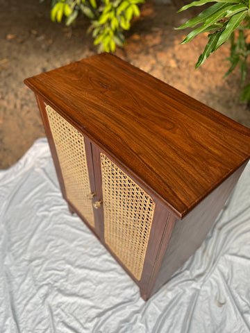 Close-up of wood grain and cane weave texture on Moro cabinet