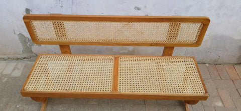 Close-up of wood grain and cane weave texture on Wevo bench
