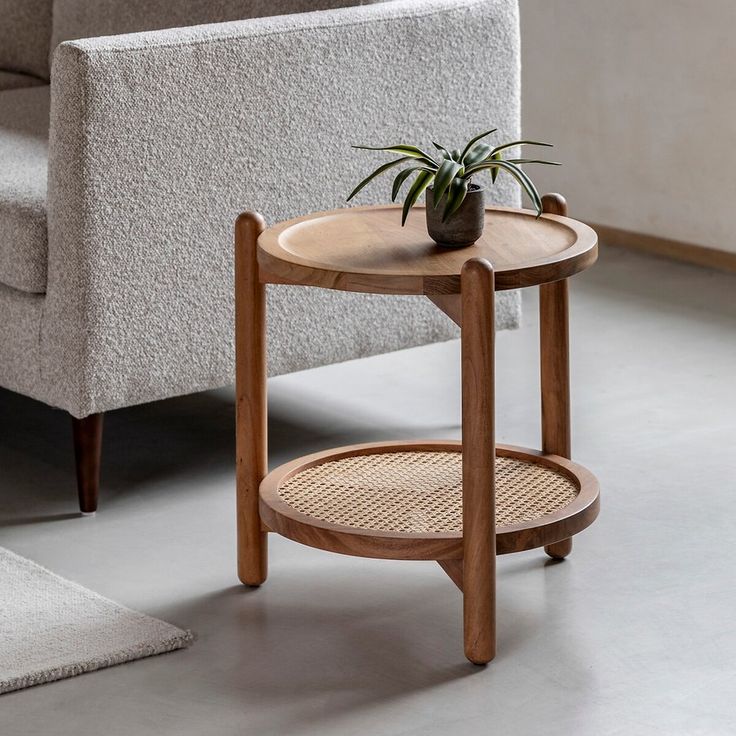 "Coastal round rattan side table with solid wood legs"