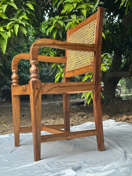 Front view of Mokaan rattan chair showing woven cane seat and backrest