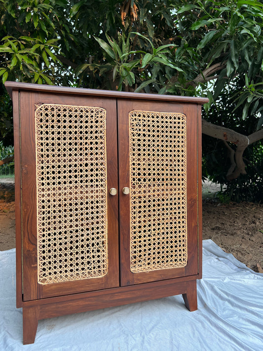 Front view of Moro rattan cabinet showing woven cane cupboard doors