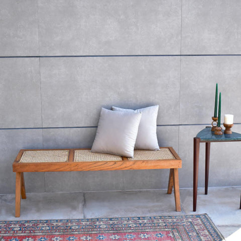 "Harbor rattan bench with woven cane seat and wood frame"