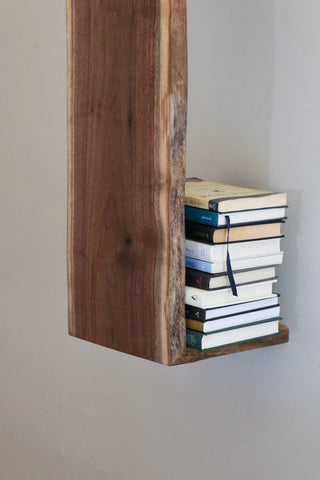 Live edge waterfall shelf close-up showing continuous wood grain