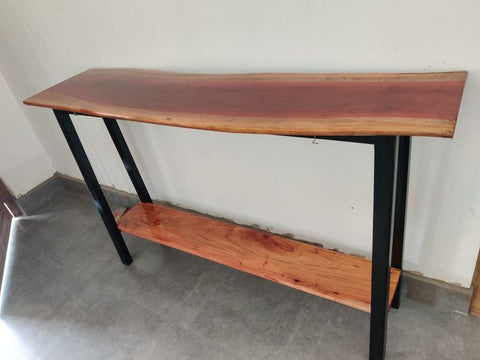 Live edge wood console table styled in hallway