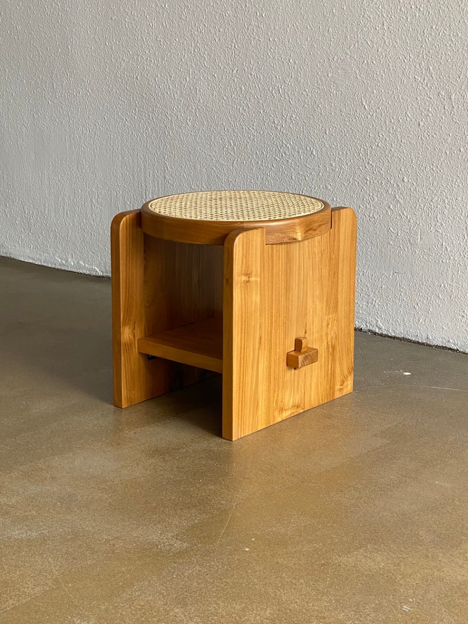"Loom rattan side table with round wood top and rattan base"