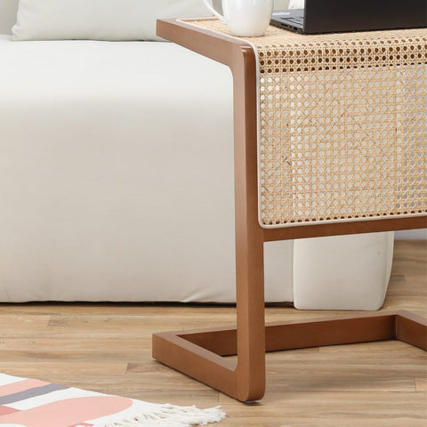 "Rattan C-shaped side table used as laptop stand"