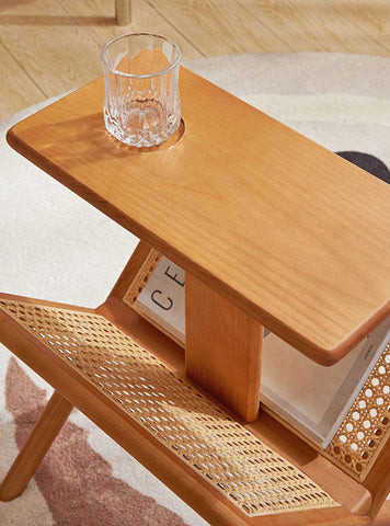 Rattan accent table placed beside a sofa or bed