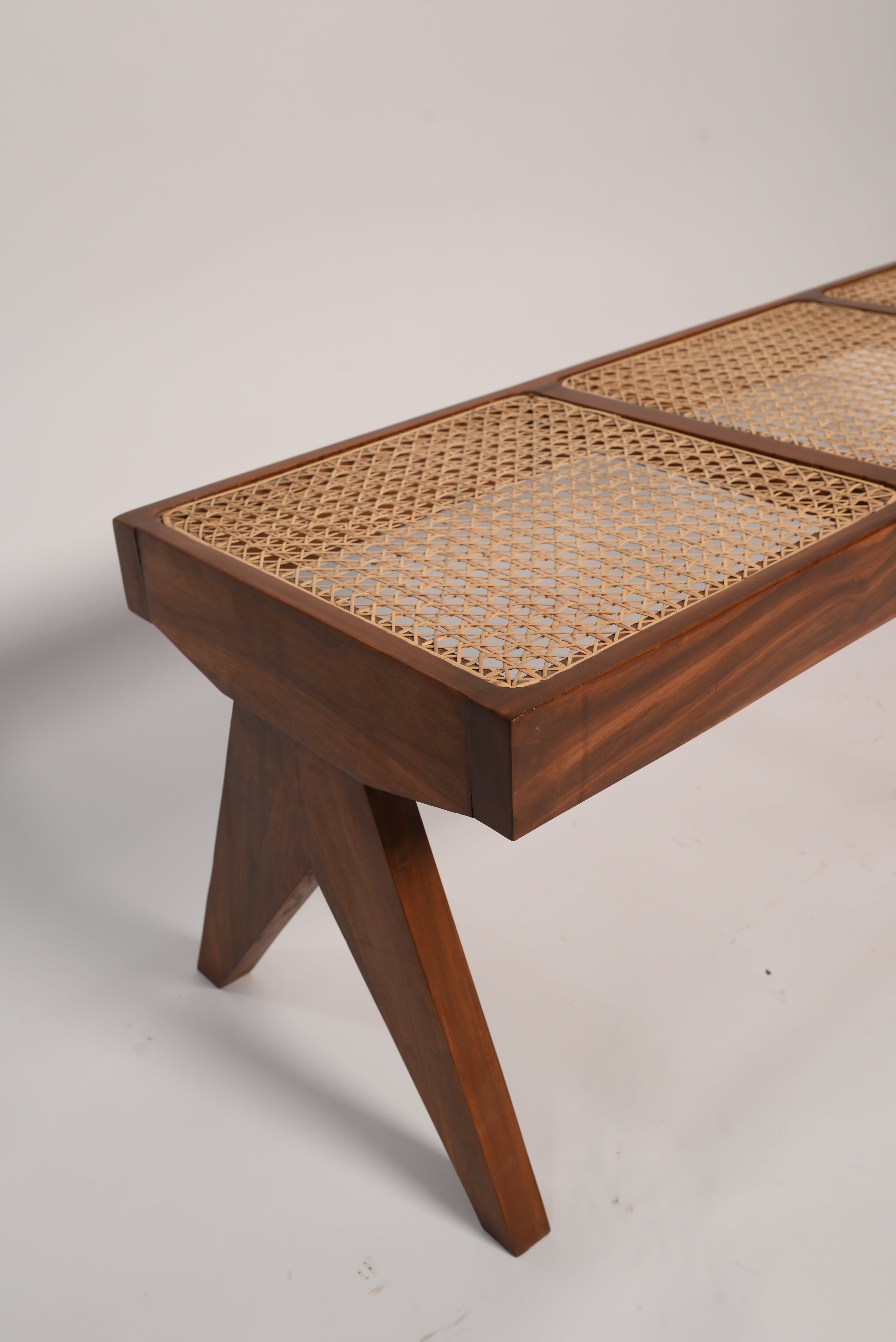 "Rattan bench on covered patio"