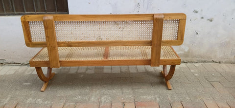 Rattan bench placed near a dining table