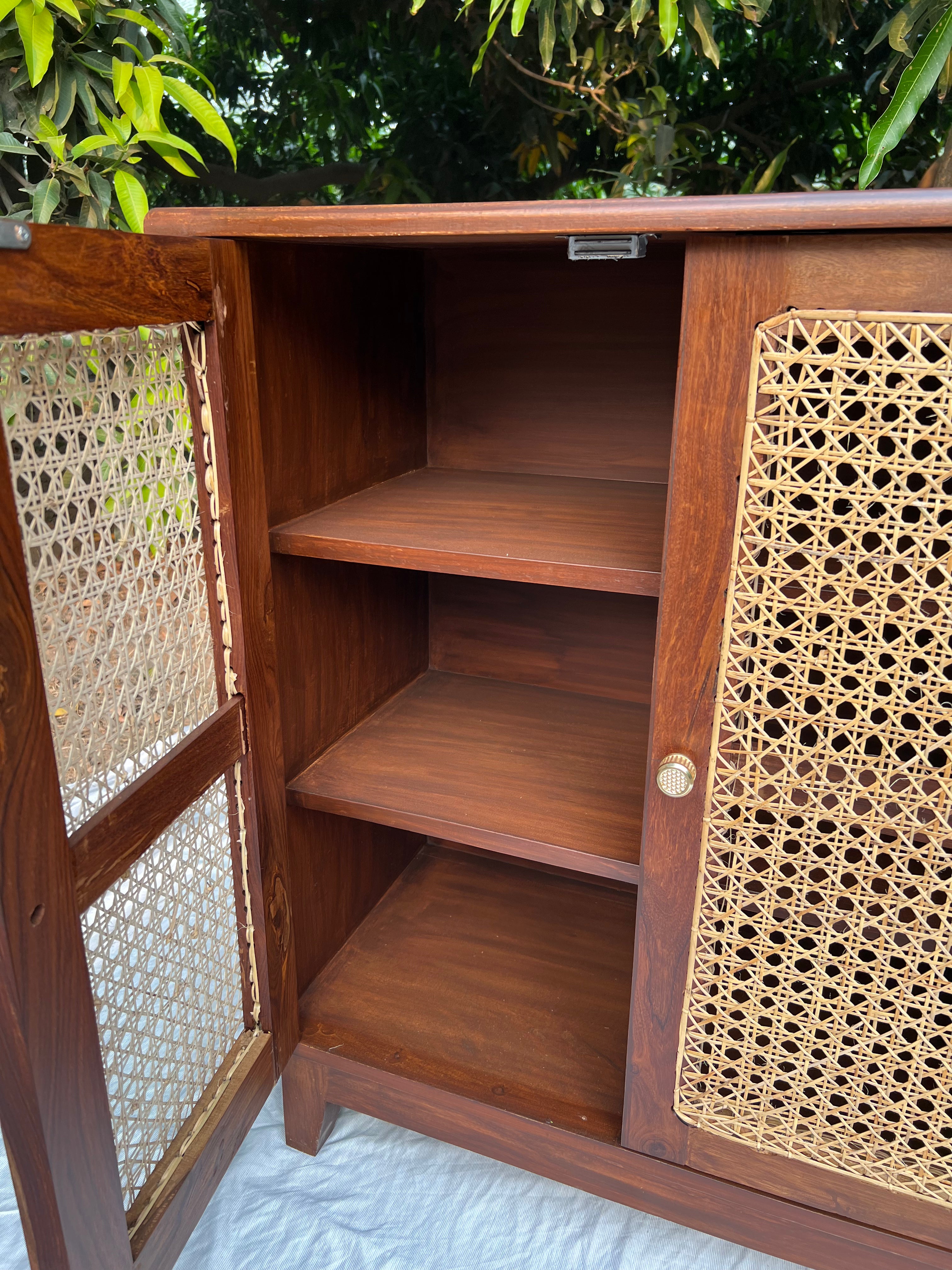 Rattan cabinet placed in bedroom interior for compact storage