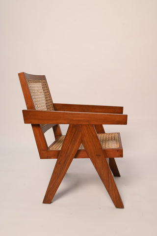 "Rattan chair side view showing wood frame and cane seat"