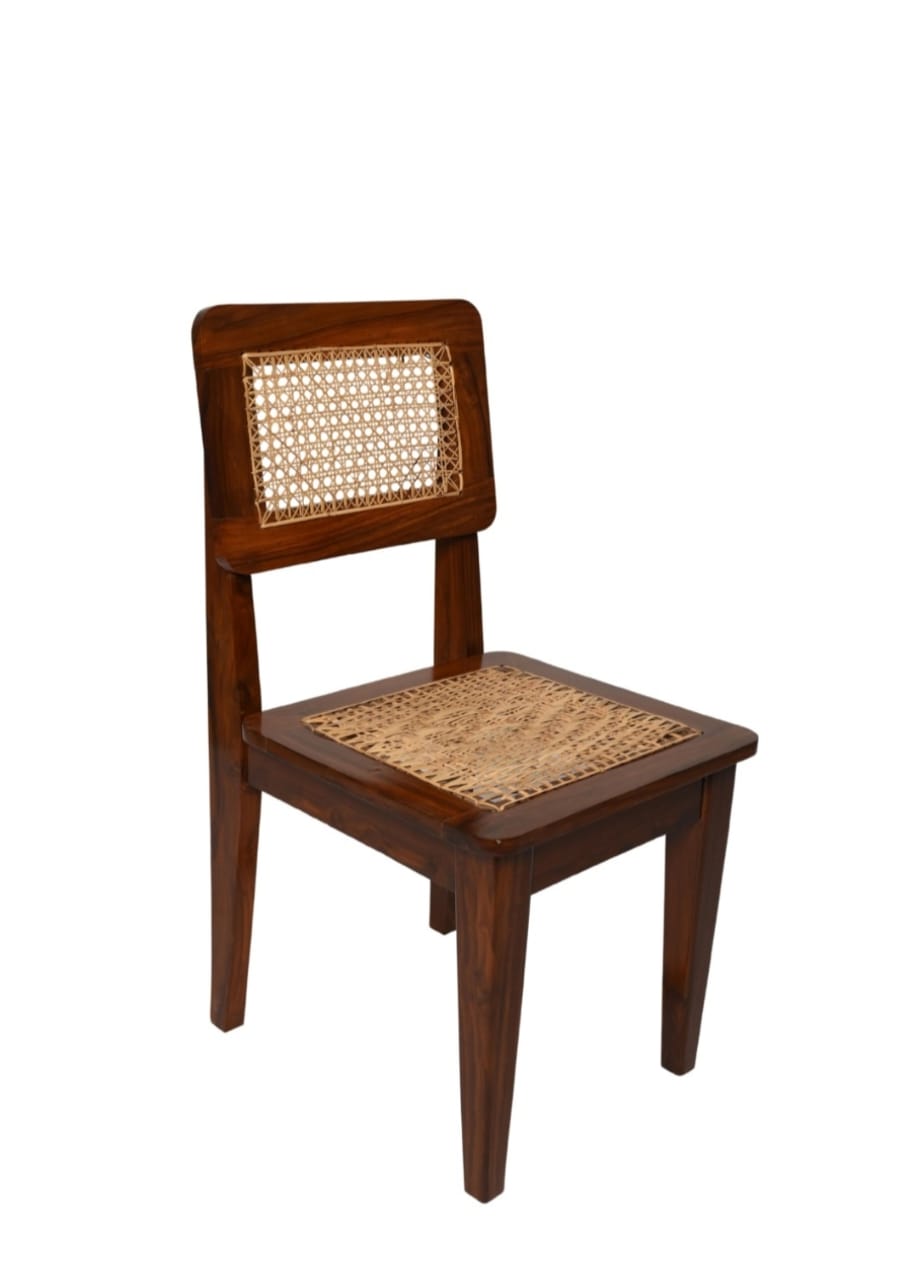 "Rattan dining chairs styled around a dining table"