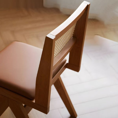 "Rattan dining chairs styled around dining table"