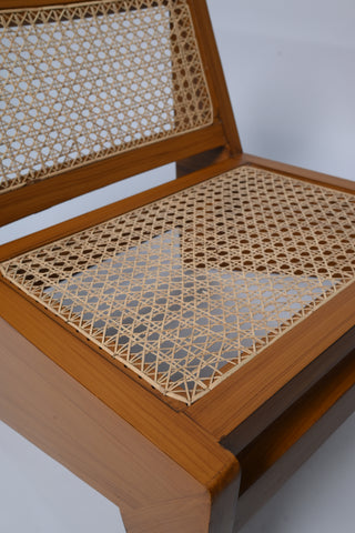 "Rattan lounge chair shown from behind, cane weave detail"