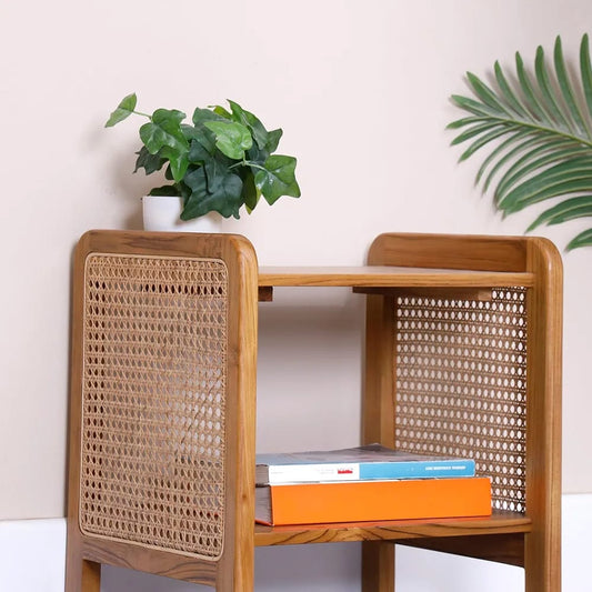 "Rattan mesh side table shown from front, glossy finish"