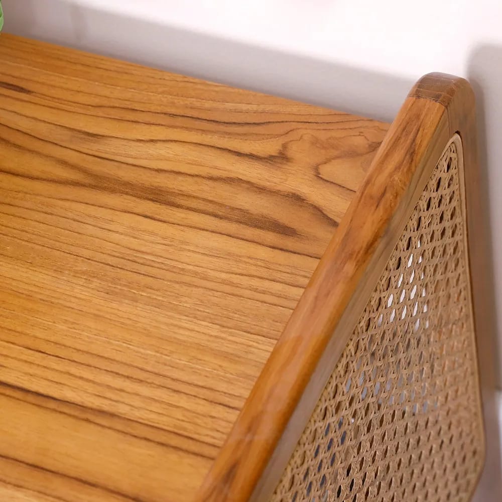 "Rattan side table used as bedroom nightstand"