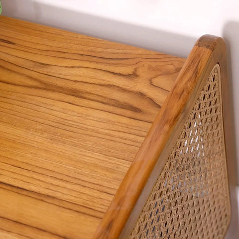 "Rattan side table used as bedroom nightstand"