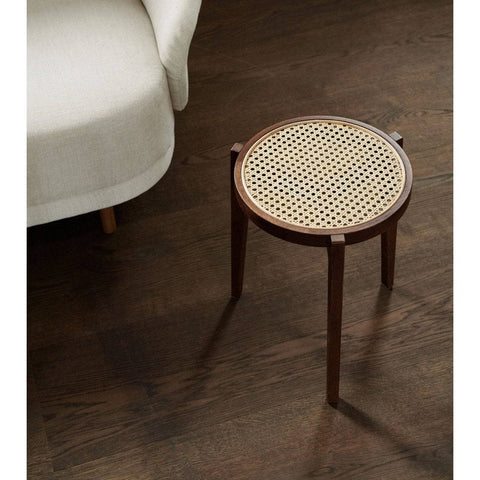 "Rattan stool side view, glossy finish"