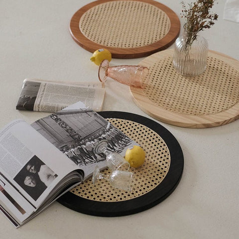 "Rattan tray used to hold plants or candles"