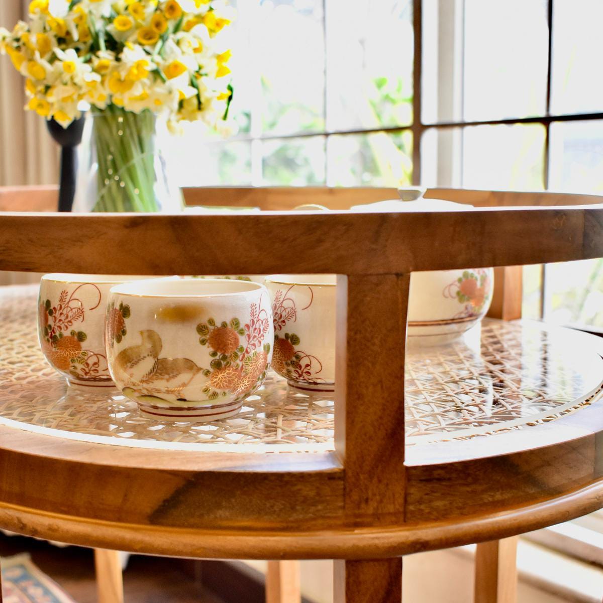 "Rattan trolley styled as bar cart with drinks"