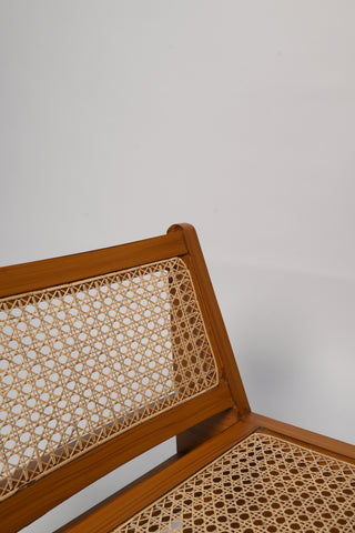 "Sheesham wood joinery detail on rattan lounge chair"