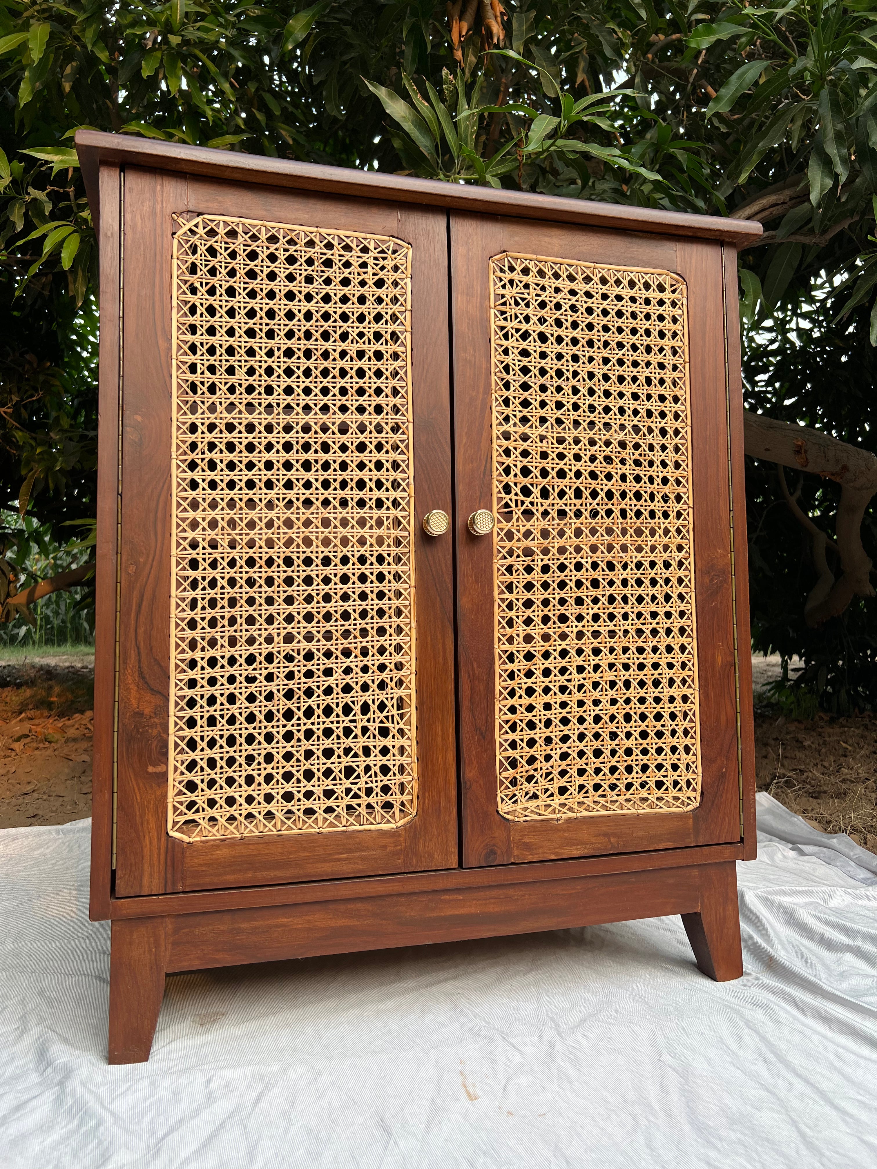 Side angle of Moro cabinet highlighting solid wood frame and cane weave