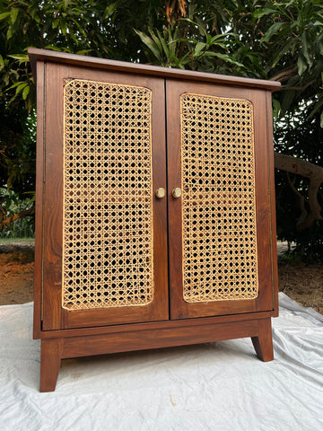 Side angle of Moro cabinet highlighting solid wood frame and cane weave