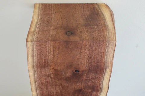 Waterfall wood shelf angled view showing single-slab design