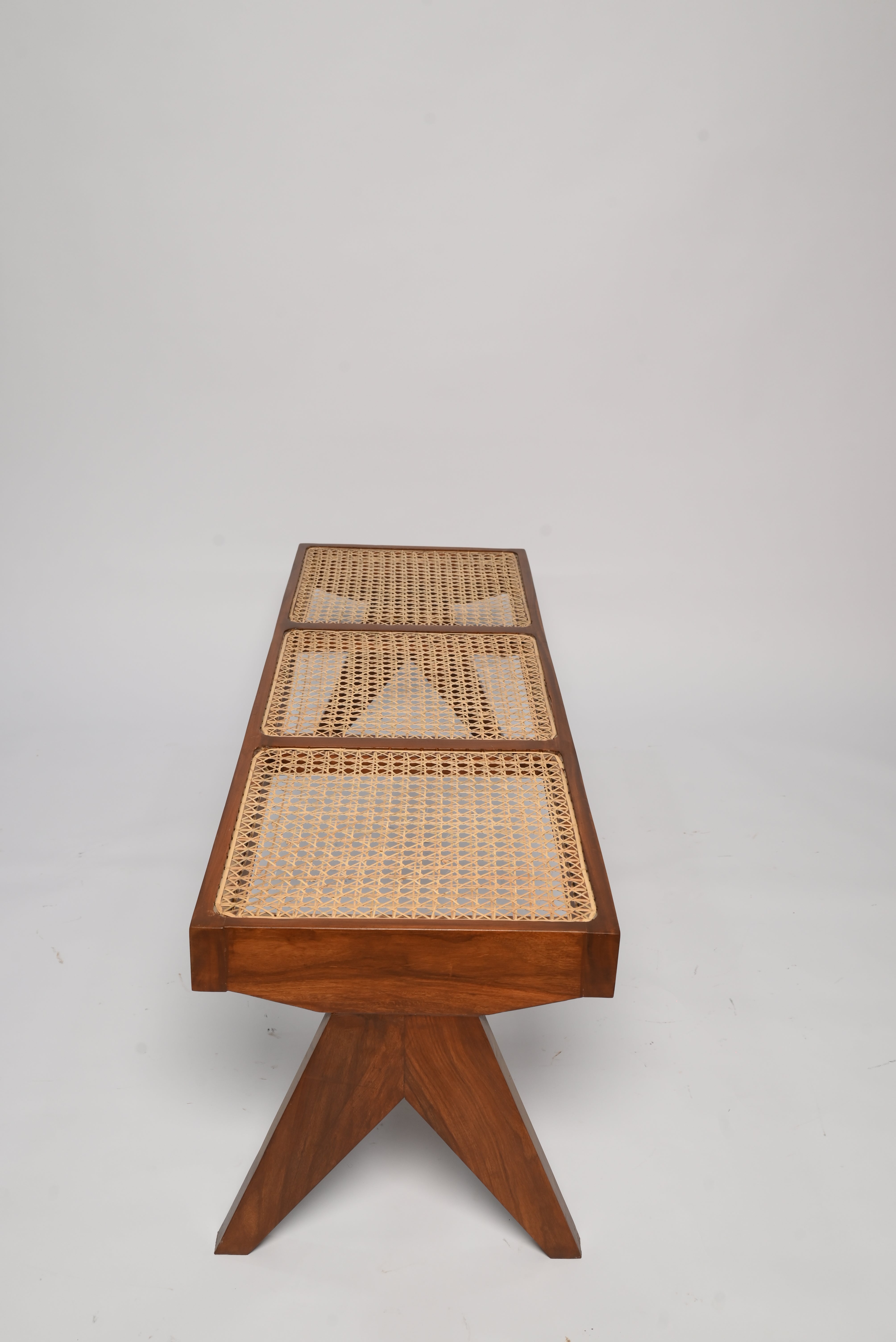 "Wood joinery detail on Harbor rattan bench"