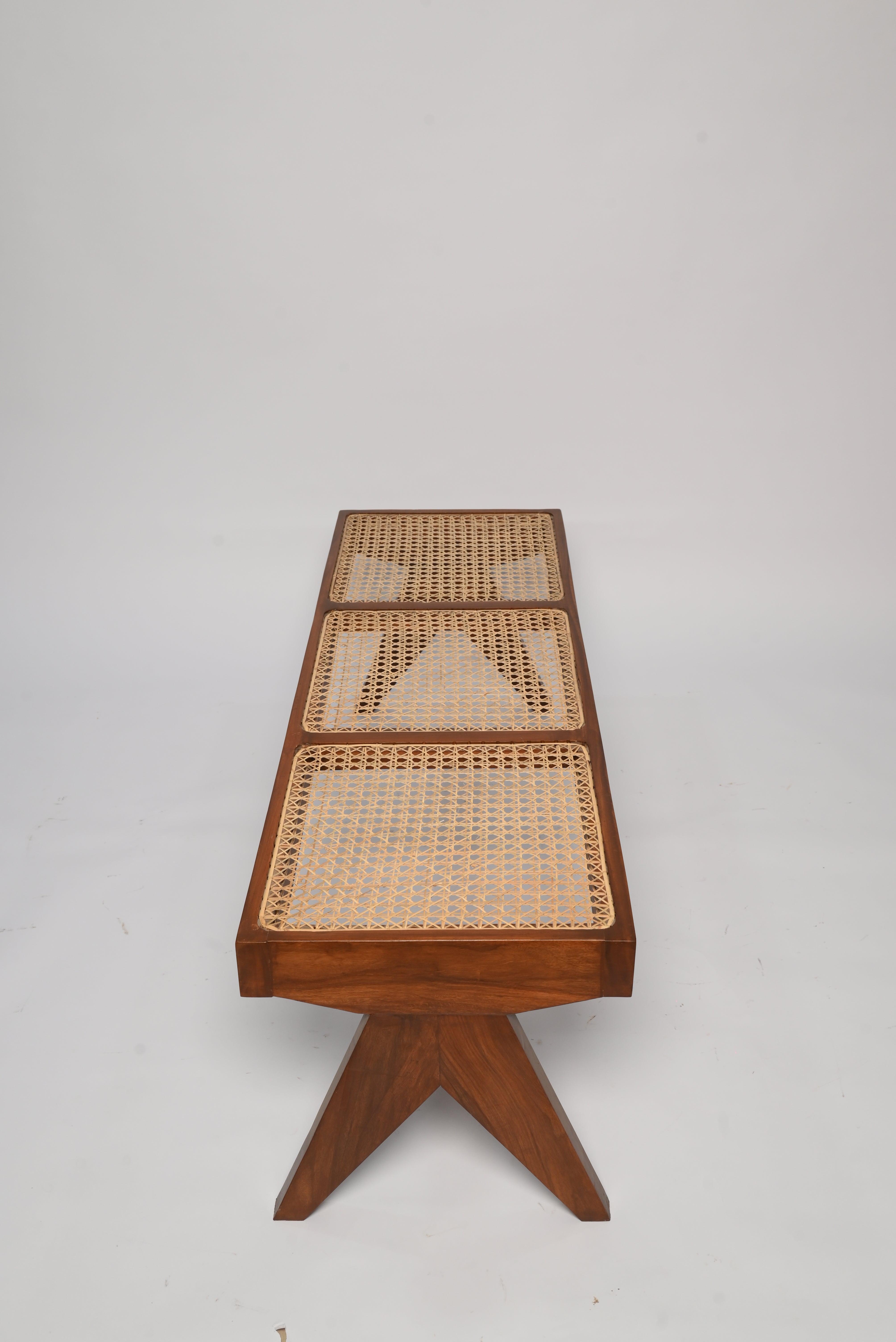 "Wood joinery detail on Harbor rattan bench"