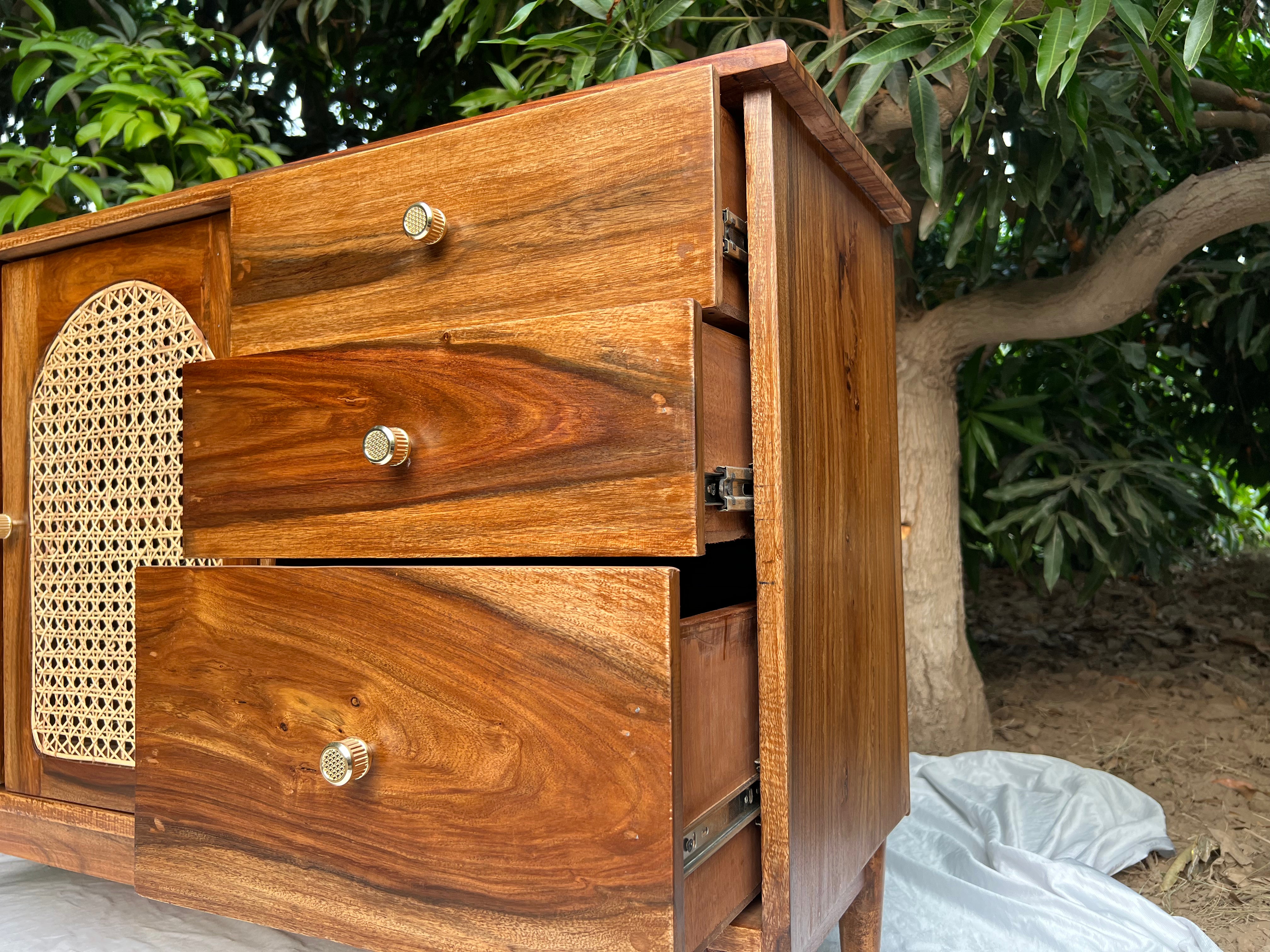 ide angle of Ravi chester highlighting solid wood frame and cane detailing