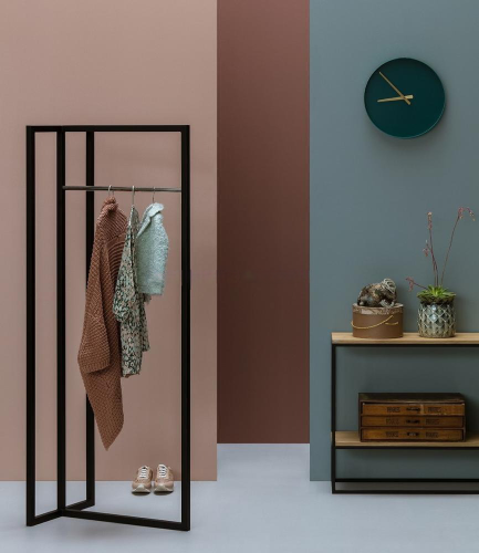 metal clothes hanger rack in bedroom